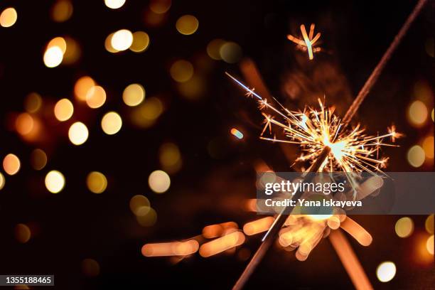 festive burning sparkles at new year celebration party - hogmanay stock pictures, royalty-free photos & images