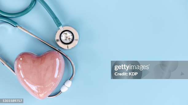 healthcare and medicine concepts, stethoscope with red heart on isolated blue background. - heart concept business stock pictures, royalty-free photos & images