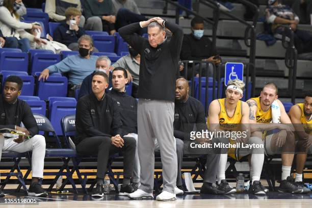 Head coach Jim Ferry of the UMBC Retrievers] signals to his players during the Jerome Kersey Classic college basketball game against the Longwood...