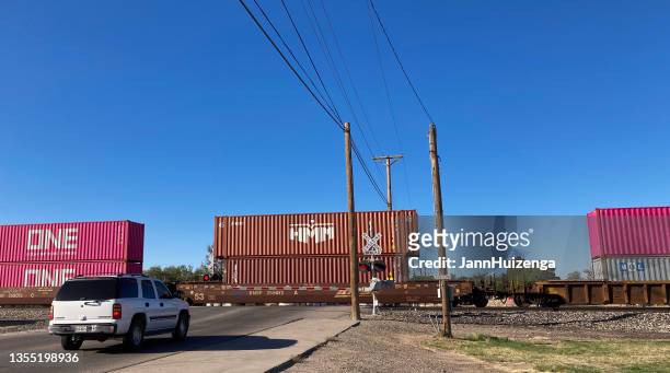 san elizario, tx: car waiting for freight train to pass - red car wire stock pictures, royalty-free photos & images
