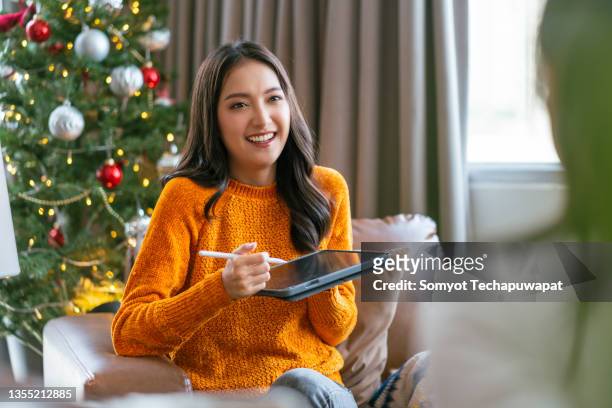 christmas holiday vacation,asian female friend spending time conversation together at home,asian female sitting on sofa couch with old senior dog talking with friend connect relation with fun and joyful at apartment - real time stock pictures, royalty-free photos & images
