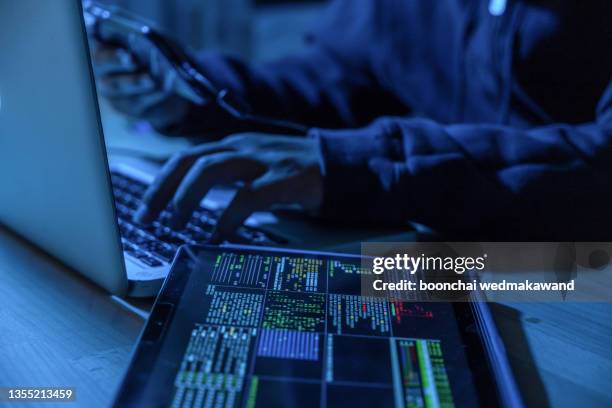 payments system hacking. online credit cards payment security concept. hacker in black gloves hacking the system. - computer crime stock pictures, royalty-free photos & images