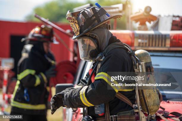 firefighters preparing and inspecting pressure and water in the fire truck inside the fire station - fireman stock pictures, royalty-free photos & images