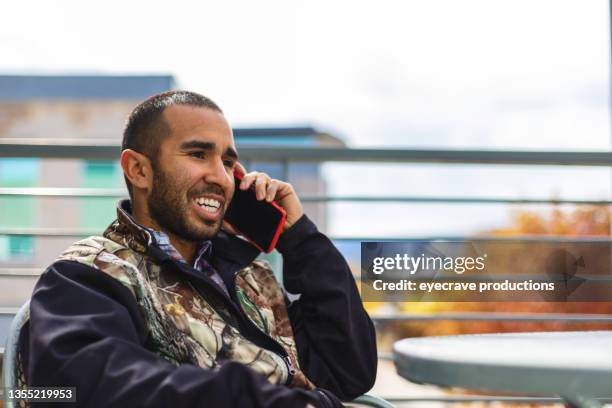 millennial male of hispanic ethnicity on high rise balcony afro-latinx lifestyle photo series - co op city stock pictures, royalty-free photos & images
