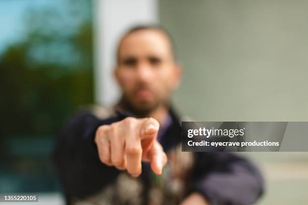 millennial male of hispanic ethnicity on high rise balcony afro-latinx lifestyle photo series - pointing stock pictures, royalty-free photos & images