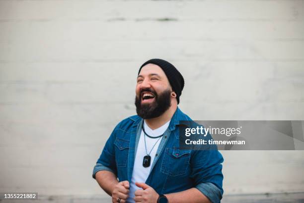 fashionable bearded man smiling in the city - handsome native american men stock pictures, royalty-free photos & images