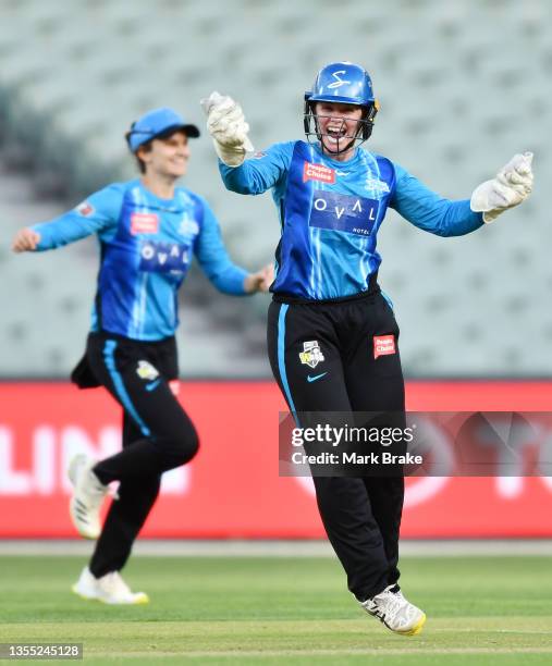 Tegan McPharlin of the Adelaide Strikers celebrates the wicket of Mikayla Hinkley of the Brisbane Heat caught by Dane Van Niekerk of the Adelaide...