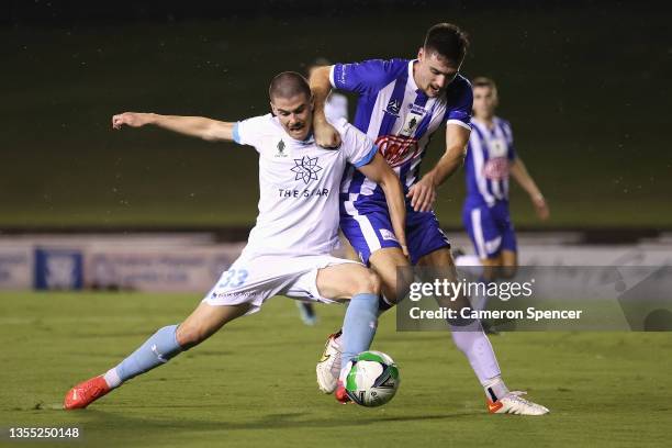 Benjamin Van Meurs of Olympic and Patrick Wood contest the ball during the FFA Cup round of 32 match between Sydney Olympic FC and Sydney FC at...