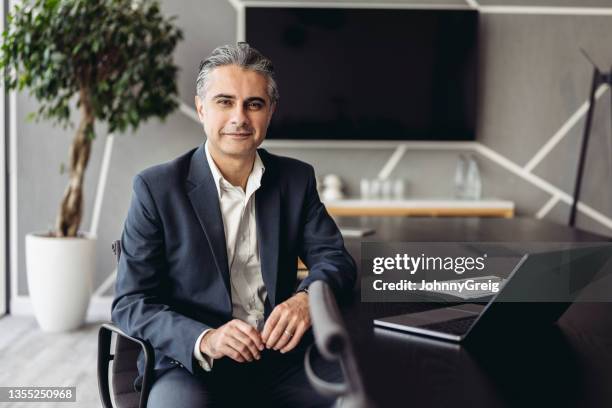 portrait of middle eastern executive working in board room - open collar stock pictures, royalty-free photos & images