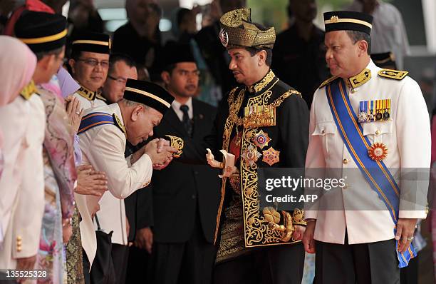 The outgoing 13th king of Malaysia, Tuanku Mizan Zainal Abidin , greets officials during a farewell ceremony at the Parliment House in Kuala Lumpur...