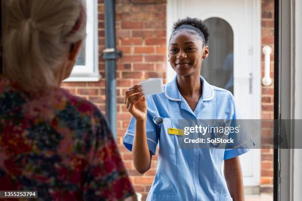 visiting a patient - district nurse stock pictures, royalty-free photos & images