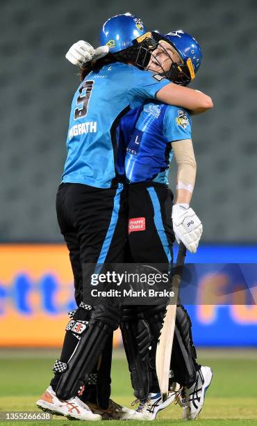 Katie Mack of the Adelaide Strikers celebrates making her half century and winning the game with Tahlia McGrath of the Adelaide Strikers during the...