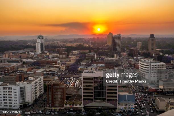 harare cbd west (jason moyo avenue - sunset) - zimbabwe stock pictures, royalty-free photos & images