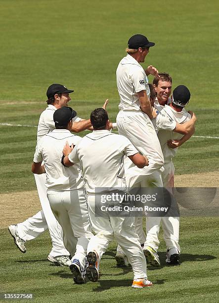 Douglas Bracewell of New Zealand is congratulated by team-mates after getting the wicket of Nathan Lyon of Australia to win the match during day four...