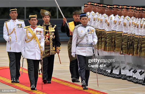 The outgoing 13th king of Malaysia, Tuanku Mizan Zainal Abidin , inspects the royal guard of honour during a farewell ceremony at the Parliment House...