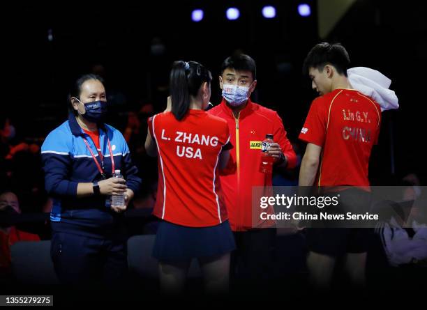 Lin Gaoyuan of China and Lily Zhang of United States talk to Chinese table tennis coach Wang Hao in the Mixed Doubles first round match against Tiago...