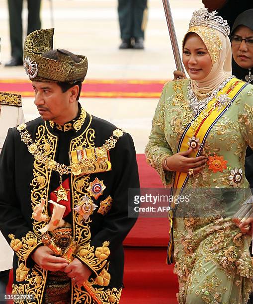 The outgoing 13th king of Malaysia, Tuanku Mizan Zainal Abidin and Queen Nur Zahirah , greet officials during a farewell ceremony at the Parliment...