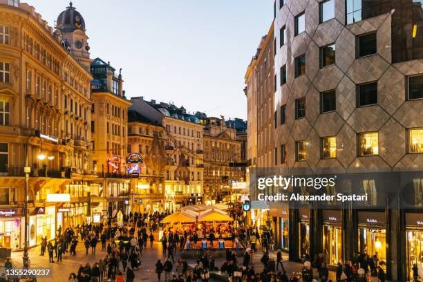 stephansplatz and crowds of people after sunset in vienna, austria - stephansplatz stock pictures, royalty-free photos & images