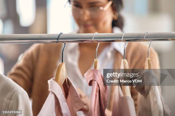 shot of a young beautiful woman shopping for clothing - coathanger stock pictures, royalty-free photos & images