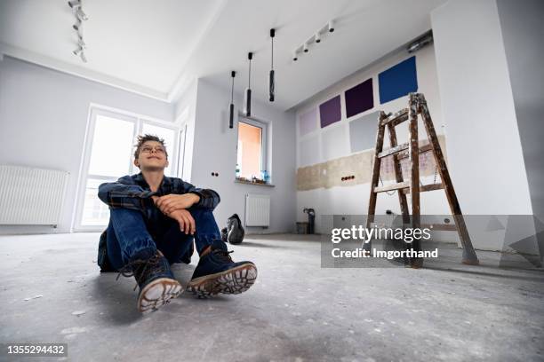 teenage boy admiring partially painted apartment - wide angle house stock pictures, royalty-free photos & images