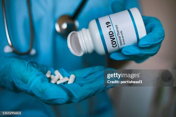 infectious doctor holding covid 19 antiviral drug - bulgaria coronavirus stock pictures, royalty-free photos & images