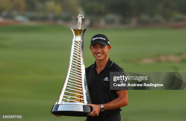 Collin Morikawa of the United States poses with the Race To Dubai trophy after winning The DP World Tour Championship at Jumeirah Golf Estates on...