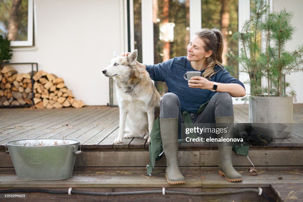 Woman working in the garden ( house, dog, resting)