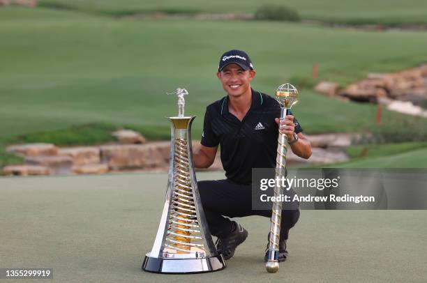 Collin Morikawa of the United States poses with both the Race To Dubai and the DP World Tour Championship trophies after winning The DP World Tour...