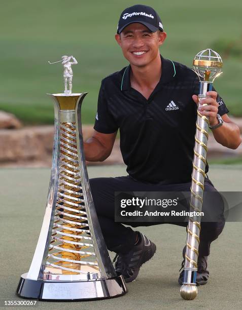 Collin Morikawa of the United States poses with both the Race To Dubai and the DP World Tour Championship trophies after winning The DP World Tour...