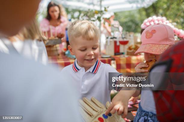 cute little boy at the outdoor summer party - animator - fotografias e filmes do acervo