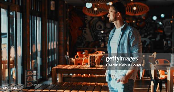 shot of a young man looking thoughtful in a restaurant - closed stock pictures, royalty-free photos & images