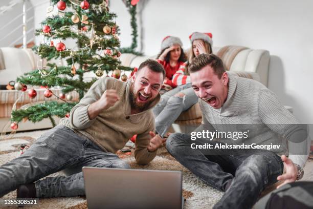 females getting bored with their boyfriends watching sports match during christmas party - gift excitement stock pictures, royalty-free photos & images