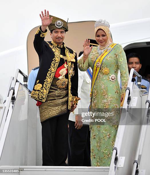 Outgoing 13th king of Malaysia, Tuanku Mizan Zainal Abidin and Queen Nur Zahirah , wave to their subjects before boarding a flight to their home...