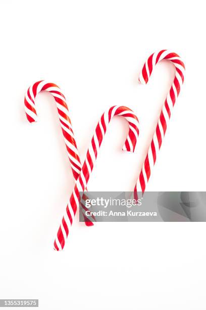 close up of candy cane isolated on white background - christmas treat stock pictures, royalty-free photos & images