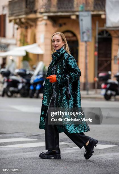 Sonia Lyson is seen wearing glitter coat Prada, bag Prada, orange gloves Prada, loafers Prada, turtleneck Prada, Choux leather pants in black on...