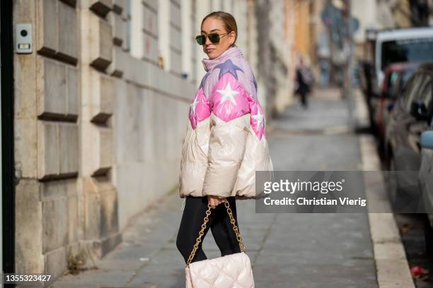 Sonia Lyson is seen wearing boots Bottega Veneta boots, leggings Lululemon, Miu Miu bag in rose, down feather coat Miu Miu with star print,...