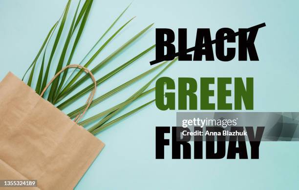 text black green friday and shopping bag with leaves. concept of overproduction and sustainable lifestyle. - fridy stock pictures, royalty-free photos & images