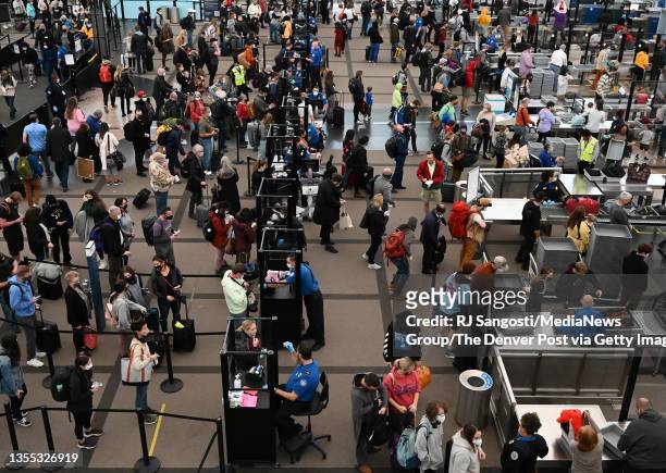 Travelers make their way through TSA security at Denver International Airport the day before Thanksgiving on November 24, 2021 in Denver, Colorado.