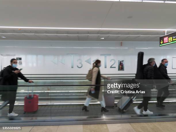 Passengers walking on the corridor mechanical belts in the Adolfo Suarez Madrid-Barajas Airport on november 10, 2021 in Madrid, Spain.