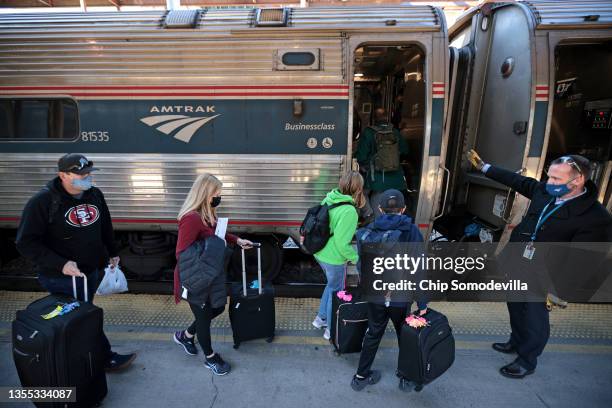 Passengers board a train bound for Boston on the day before Thanksgiving at Union Station on November 24, 2021 in Washington, DC. Amtrak is working...