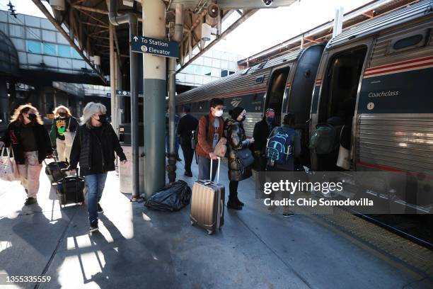 Passengers board a train bound for Boston on the day before Thanksgiving at Union Station on November 24, 2021 in Washington, DC. Amtrak is working...