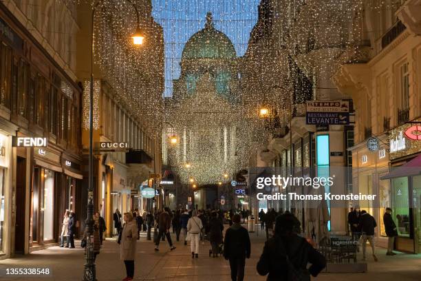 People walk past closed shops at 'Kohlmarkt' shopping street on the third day of a nationwide, temporary lockdown during the fourth wave of the novel...