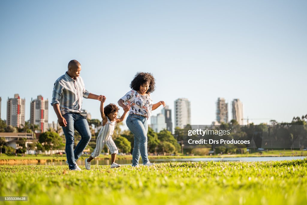 Family strolling in the late afternoon in the city park