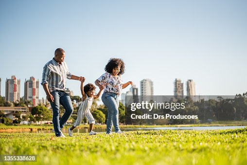 Family strolling in the late afternoon in the city park Family strolling in the late afternoon in the city park