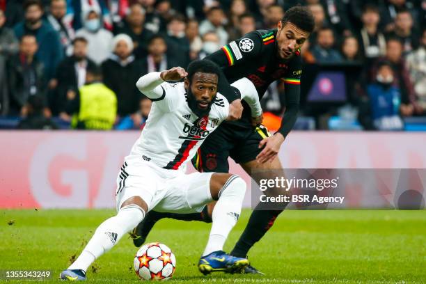 Georges-Kevin N'Koudou of Besiktas JK battles for the ball with Noussair Mazraoui of Ajax during the UEFA Champions League Group Stage match between...
