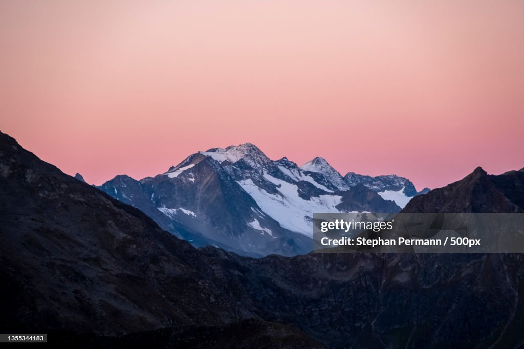 Scenic view of snowcapped mountains against sky during sunset