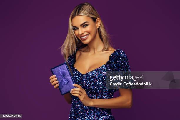 beautiful emotional woman wearing shiny dress - glamour presents stock pictures, royalty-free photos & images