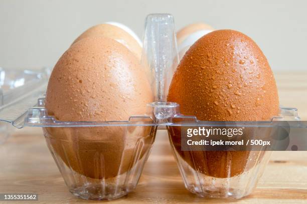 close-up of eggs in carton on table - ipek morel stock pictures, royalty-free photos & images