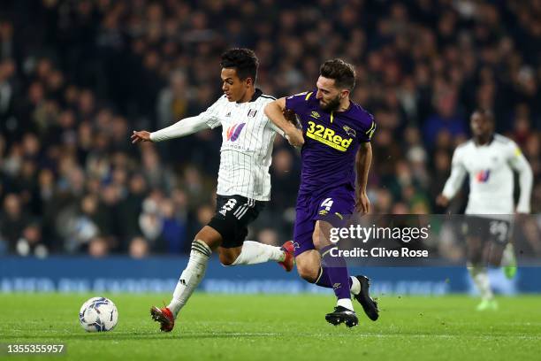 Fabio Carvalho of Fulham battles for possession with Graeme Shinnie of Derby County during the Sky Bet Championship match between Fulham and Derby...