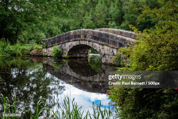 view of arch bridge over river,leeds and liverpool canal tow path,burscough,united kingdom,uk - liverpool england fotografías e imágenes de stock